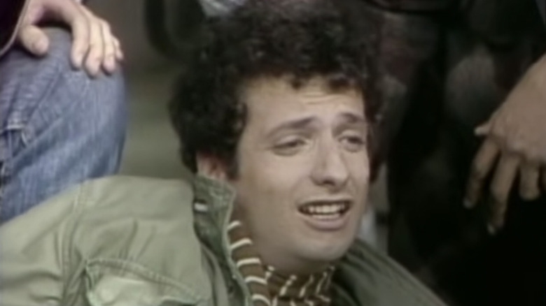 Arnold Horshack laying on the floor, grimacing