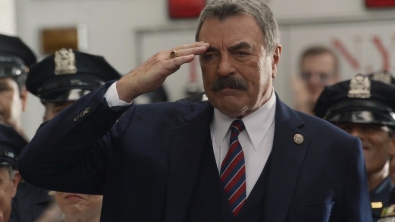 Frank Reagan wearing a suit and saluting on "Blue Bloods"