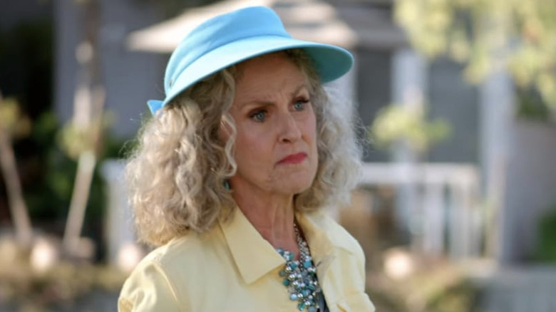 Arrested Development Rose outside in blue hat and yellow jacket