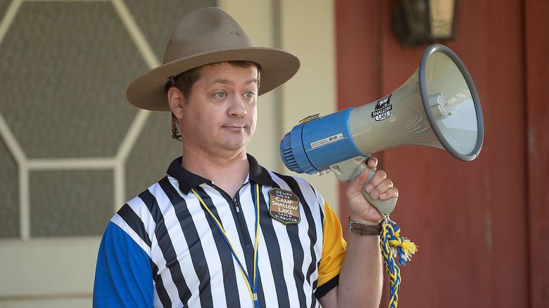 Jason Earles as Dewey Wood, holding a megaphone on High School Musical: The Musical: The Series