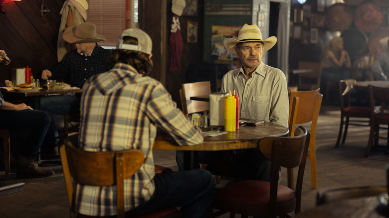 Jacob Lofland as Cooper, Billy Bob Thornton as Tommy sit at a table in Landman