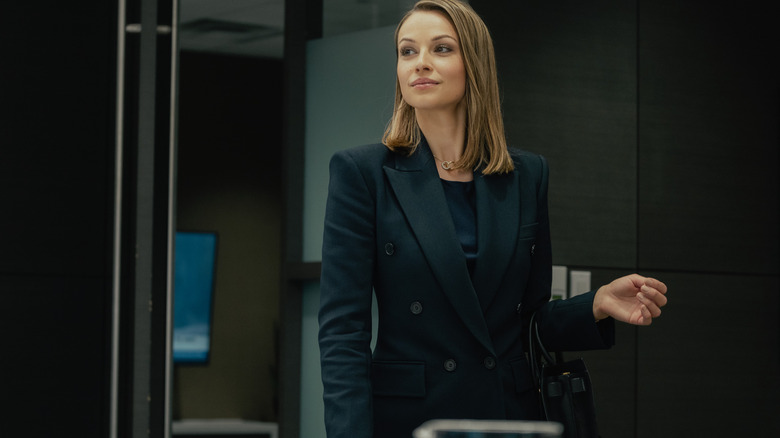 Kayla Wallace as Rebecca stands in a conference room in Landman