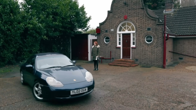 A car parked in front of the Taskmaster House