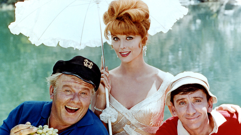 Alan Hale Jr. as the Skipper, Tina Louise as Ginger Grant, and Bob Denver as Gilligan posing for a promo photo for Gilligan's Island
