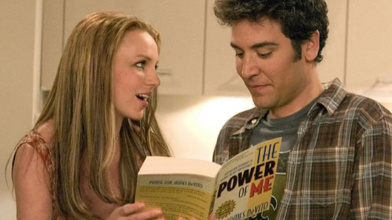 Abby holds a book while fawning over Ted Mosby in "How I Met Your Mother"