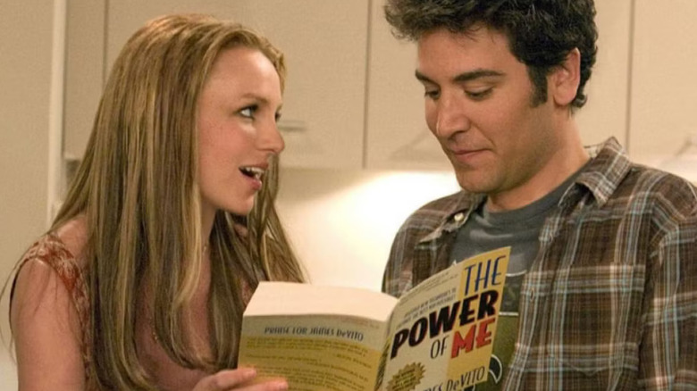 Abby holds a book while fawning over Ted Mosby in "How I Met Your Mother"