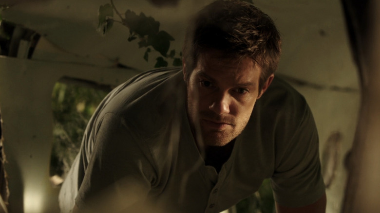 Walter Sherman is seen investigating the inside of a downed plane on The Finder (2012)