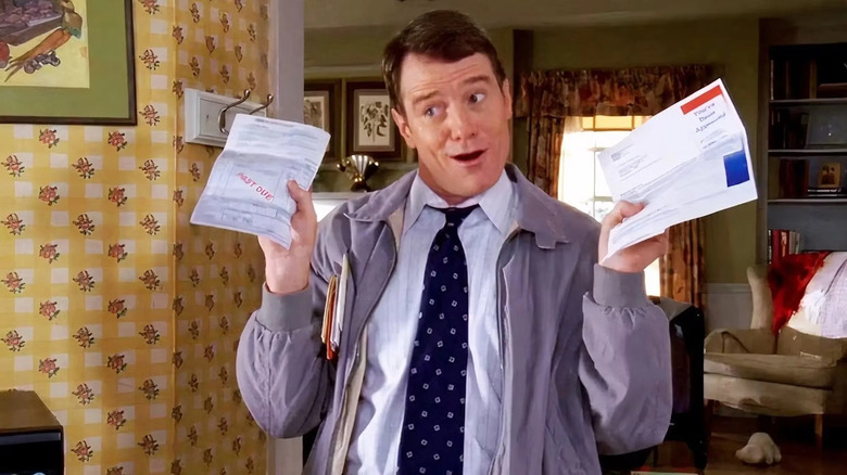 Bryan Cranston as Hal on Malcolm in the Middle, holding up some overdue bills