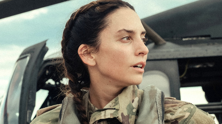 Josie Carrillo in military gear by a black helicopter in "Lioness" (2023)