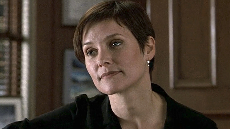 Jamie Ross wearing a black shirt sitting in an office in Law & Order