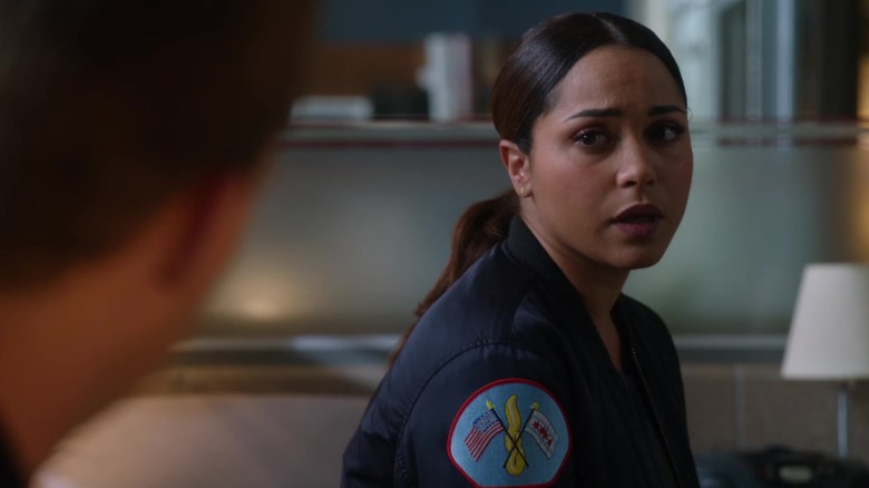 Gabby Dawson looking at a co-worker with concern in her eyes while sitting down