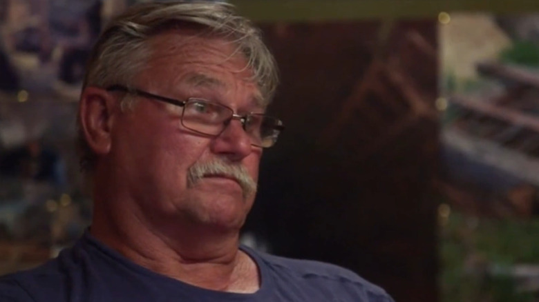 Dave Blankenship frowns and stares offscreen in "The Curse of Oak Island"