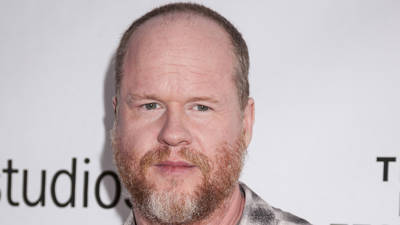 Joss Whedon posing for red carpet photos in 2016