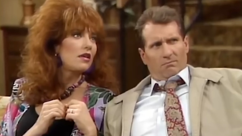 Peg and Al Bundy sitting on couch