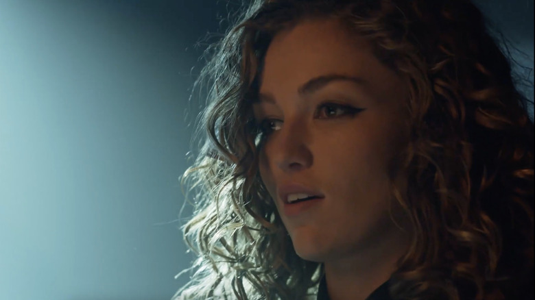 Older Selina Kyle looks in disbelief at something off camera
