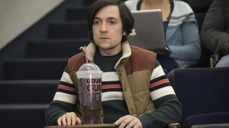Josh Brener's Nelson "Bighead" Bighetti sits in a lecture hall with a giant slushie in Silicon Valley