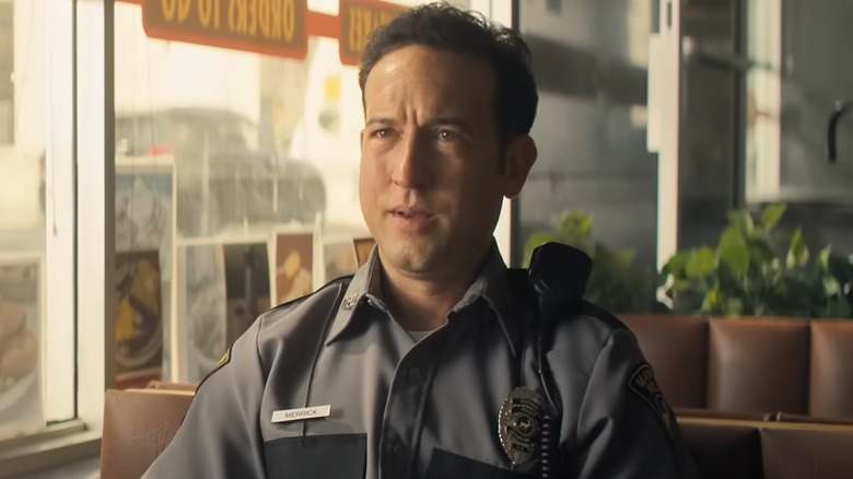 Officer Jacob Merrick sitting in a diner in "Reacher" Season 4