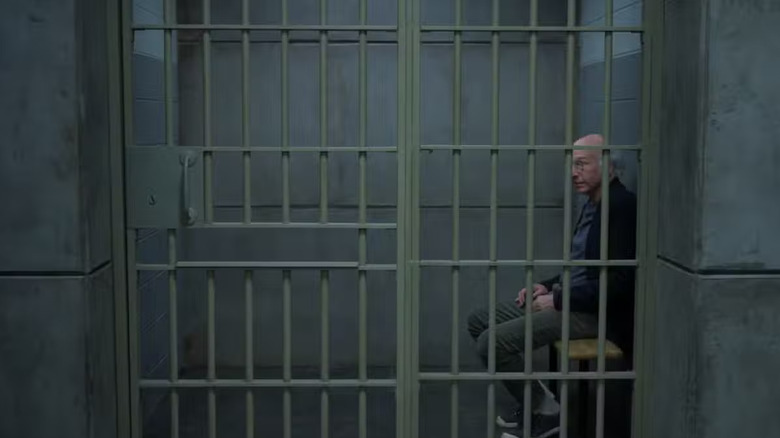 Larry David sits behind the bars of a prison cell, alone, in "Curb Your Enthusiasm"