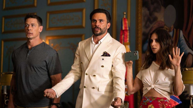 Mason (John Cena), Juan (Juan Pablo Raba) and Claire (Alison Brie) standing next to each other in "Freelance."