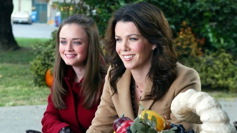 Rory and Lorelai Gilmore sitting next to each other on "Gilmore Girls"