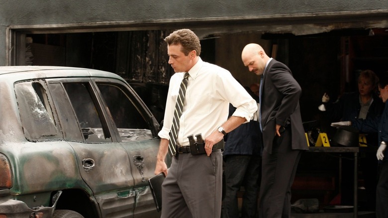 Rex (Skeet Ulrich) looking at a wrecked car on "Law & Order: Los Angeles"