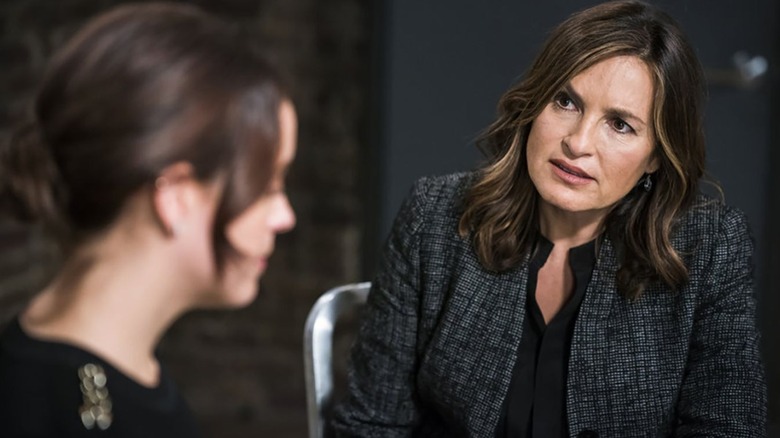 Olivia Benson sits in a metal chair while talking to a young woman in the police headquarters in "Law & Order: SVU"