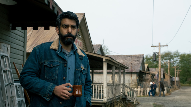 Sheriff Hassan drinking coffee outside in the morning in Midnight Mass (2021)