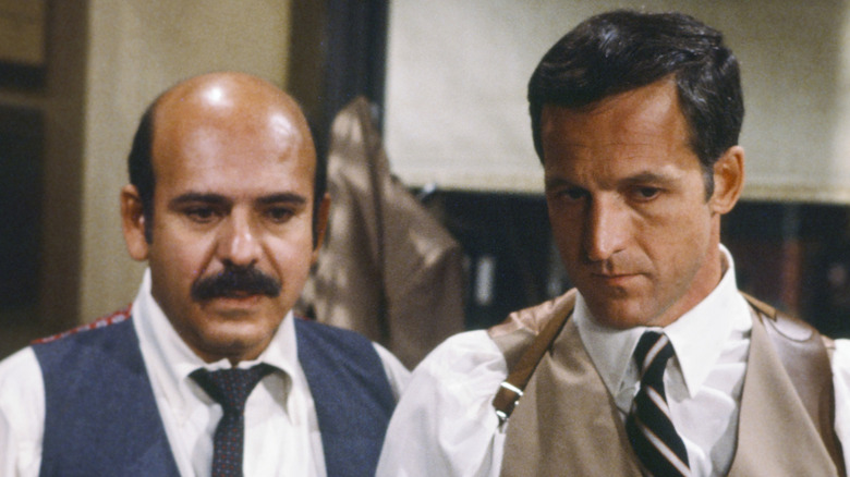 Lt. Calletano stands next to Captain Furillo as they look ahead with concern