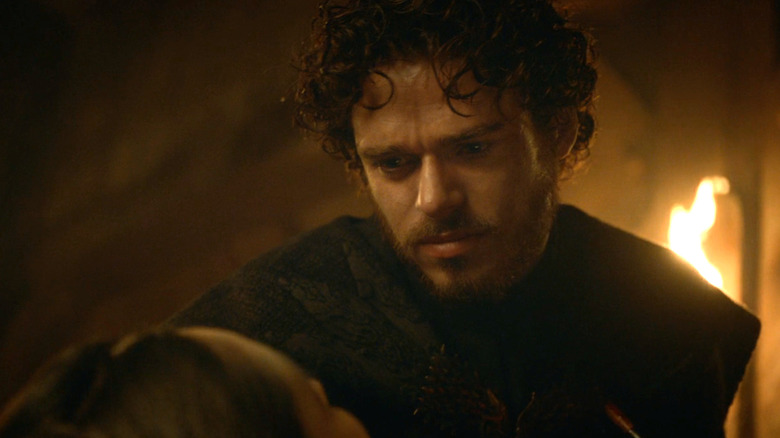 Robb Stark looking down at his dead wife Talisa in Game of Thrones