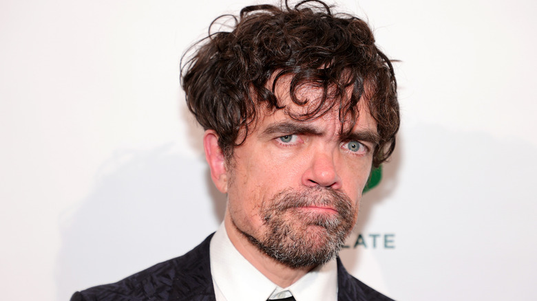 Peter Dinklage posing stoically at event