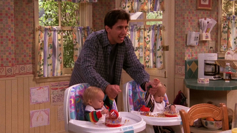Ray standing over two babies on "Everybody Loves Raymond"