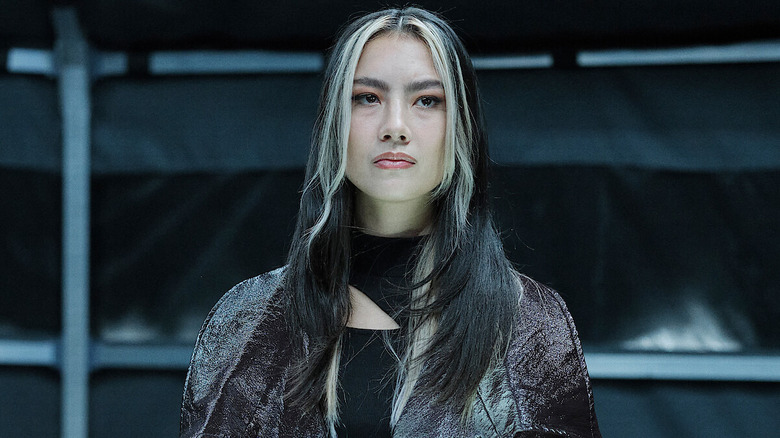 Billie Wesker standing in a lab in "Resident Evil" (2022)