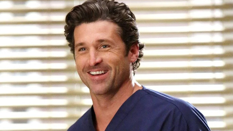 Patrick Dempsey's Derek Shepherd smiling and wearing scrubs on Grey's Anatomy