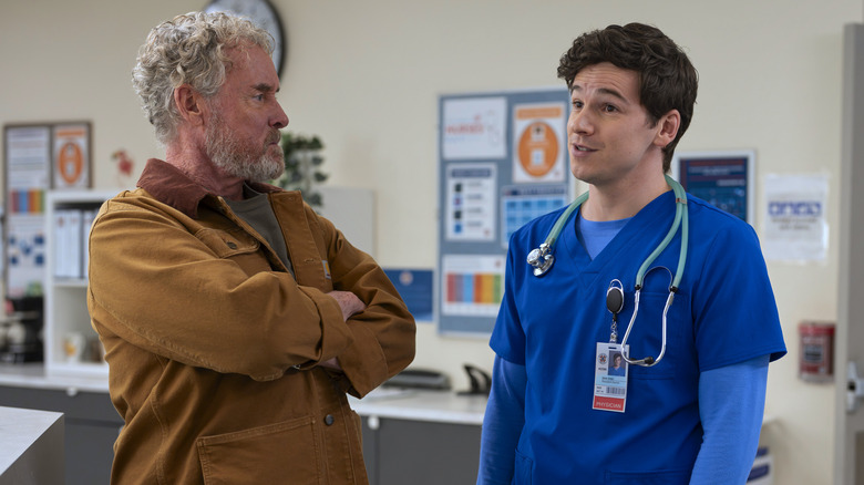 Dr. Cox with arms folded talking to Dr. Asher Green