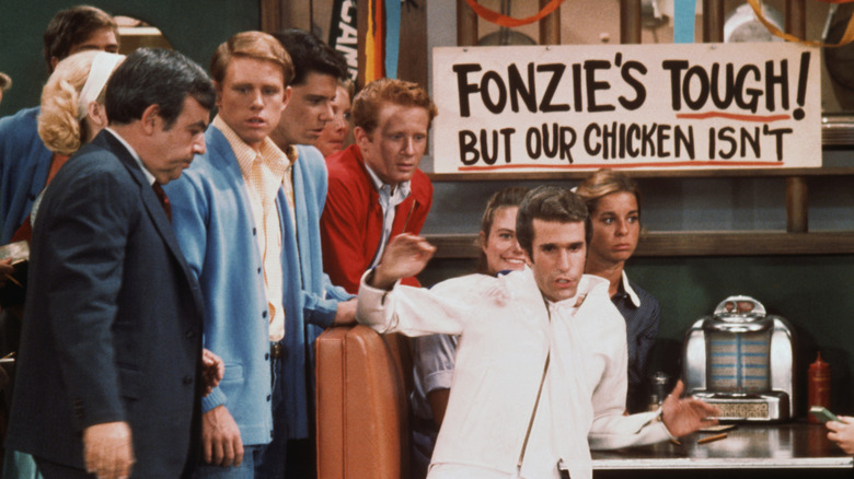 the cast of "Happy Days" (1974) filming a scene on set