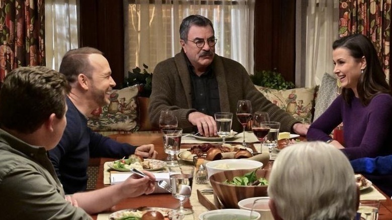 Frank Reagan sitting at the head of the dining room table during a Reagan family dinner