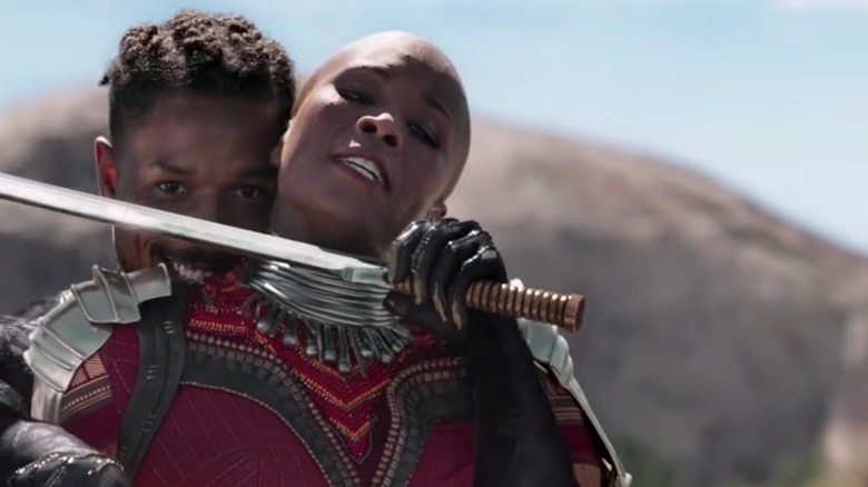 Erik Killmonger holding a sword to Xoliswa of the Dora Milaje