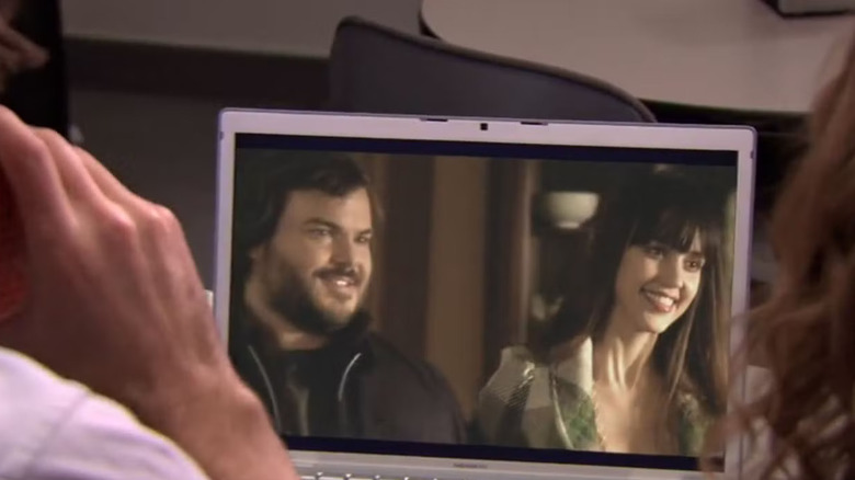 Jack Black and Jessica Alba smiling on a computer screen in "The Office"
