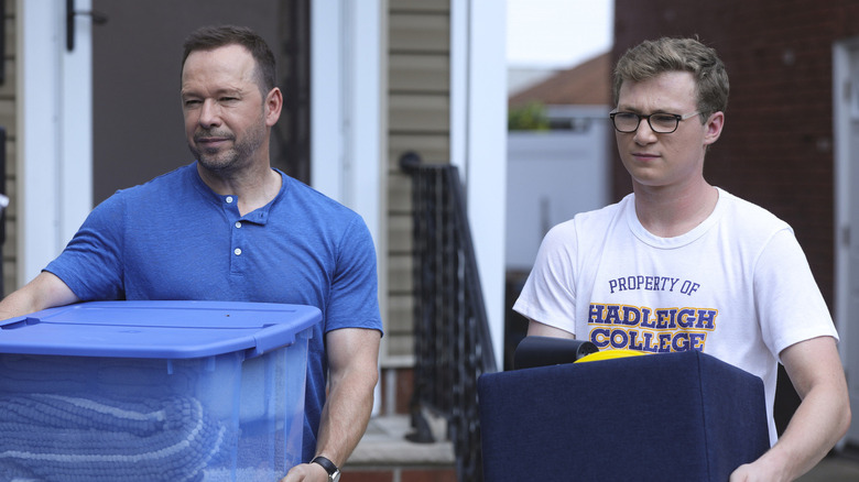 Danny and Jack Reagan holding moving tubs in Blue Bloods
