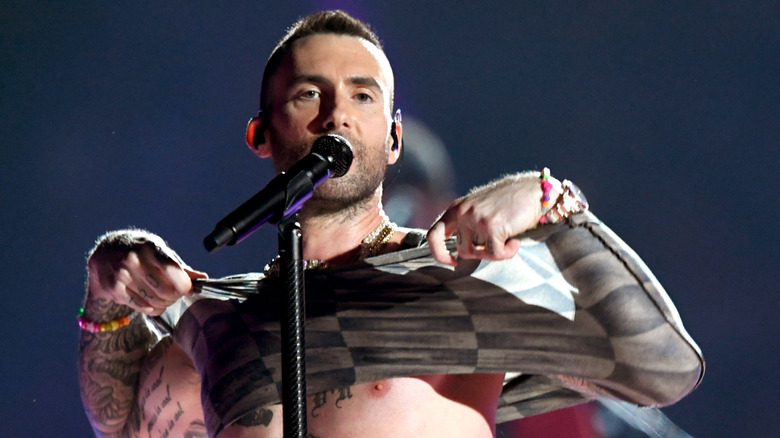 Adam Levine taking off his shirt at the Super Bowl LIII halftime show