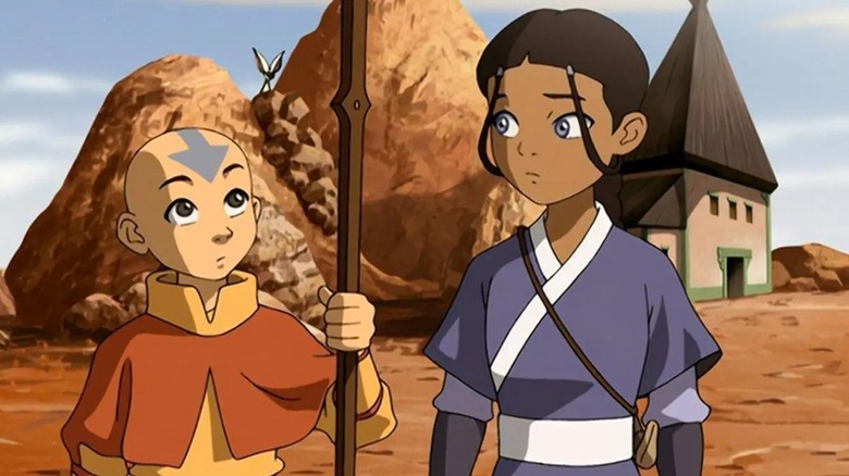 Aang holding a wooden staff next to Katara in "Avatar: The Last Airbender"