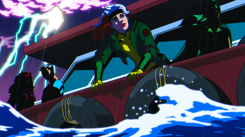 An image of four people on a boat in a storm. On the right, there is a woman with long curly hair in a red outfit and crown with a man in a blue outfit with white hair, their faces are both hidden in shadow. In the middle is a woman peering overboard wearing a green jacket with a yellow and green costume underneath. She has white and brown hair. On the right is a woman with green hair dressed in a green outfit and a cape who is also hidden by shadow.