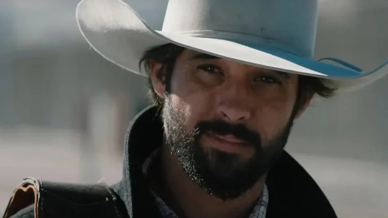 Ryan Bingham's Walker smiling and wearing a white hat on Yellowstone