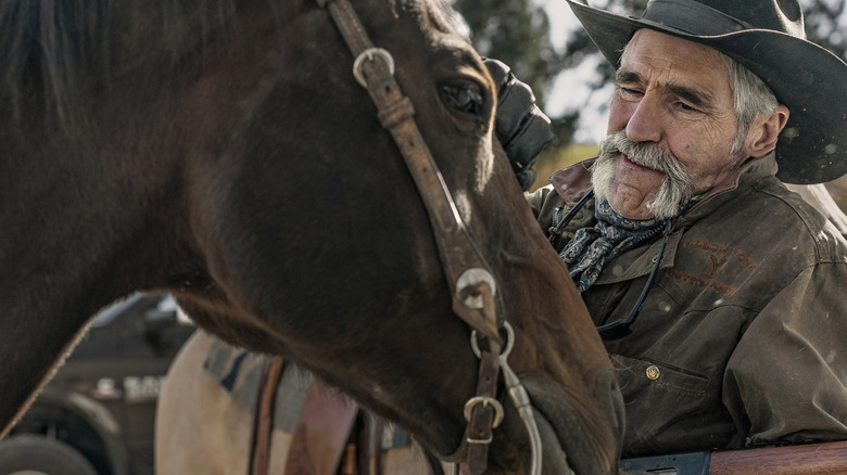Lloyd Pierce (Forrie J. Smith) pets his horse tenderly in Yellowstone