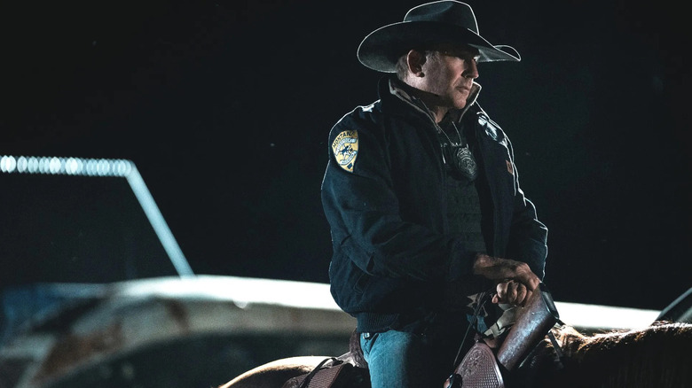 John Dutton (Kevin Costner) sits sternly on a horse at night in Yellowstone