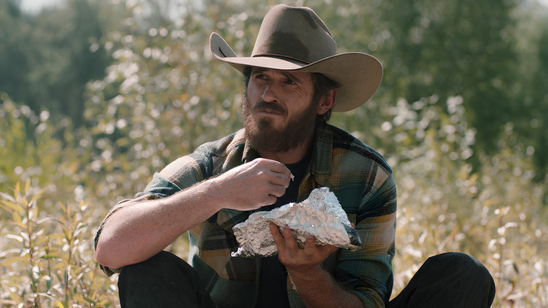 Lee Dutton (Dave Annable) sitting in the grass on "Yellowstone."